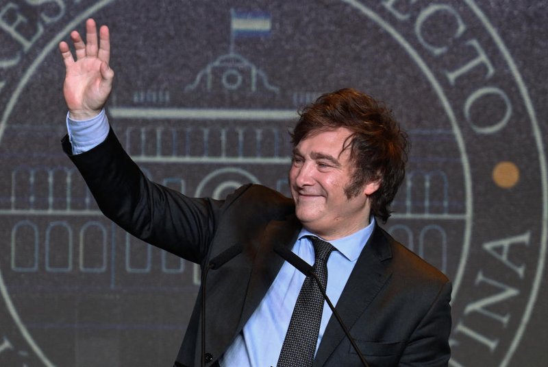 Argentine presidential candidate for the La Libertad Avanza alliance Javier Milei waves to supporters after winning the presidential election runoff at his party headquarters in Buenos Aires on November 19, 2023. Libertarian outsider Javier Milei pulled off a massive upset Sunday with a resounding win in Argentina's presidential election, a stinging rebuke of the traditional parties that have overseen decades of economic decline. (Photo by Luis ROBAYO / AFP)<!-- NICAID(15603004) -->