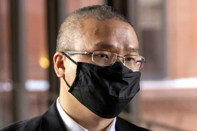 (FILES) In this file photo taken on January 11, 2022 former Minneapolis Police Officer Tou Thao arrives at the US District Court in St. Paul, Minnesota, for the pre-trial of three former Minneapolis police officers charged with federal civil rights violations in George Floyds death. - A former Minneapolis police officer charged with violating the civil rights of George Floyd took the witness stand on February 15, 2022 to defend his actions during the fatal May 2020 arrest of the 46-year-old Black man. Tou Thao, 35, is one of three former policemen on trial for their roles in Floyd's murder and the first to testify publicly about what happened that day. (Photo by Kerem Yucel / AFP)<!-- NICAID(15017843) -->