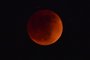 The blood moon is seen during a total eclipse in Montebello, California on May 15, 2022. (Photo by Frederic J. BROWN / AFP)<!-- NICAID(15096907) -->