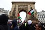 Protesters wave Palestinian flags past the Saint-Denis Gate during a demonstration calling for an immediate ceasefire in the Gaza strip, at the Place de la Republique in Paris, on March 9, 2024. (Photo by Emmanuel Dunand / AFP)<!-- NICAID(15701083) -->