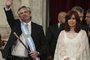 Argentina's new president Alberto Fernandez (L) waves next to his vice-president Cristina Fernandez de Kirchner, after receiving the presidential sash from outgoing president Mauricio Macri during his inauguration ceremony at the Congress in Buenos Aires on December 10, 2019. (Photo by Alejandro PAGNI / AFP)
