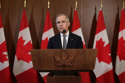 Canada's Prime Minister Mark Carney speaks to the media after meeting with his cabinet to deal with the US auto tariffs on March 27, 2025 on Parliament Hill in Ottawa. The era of deep economic, security and military ties between Canada and the United States "is over," Prime Minister Mark Carney said, a day after US President Donald Trump announced steep auto tariffs. (Photo by Dave Chan / AFP)<!-- NICAID(16004932) -->