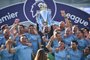 Manchester City's Spanish manager Pep Guardiola (C) lifts the Premier League trophy with staff members after their 4-1 victory in the English Premier League football match between Brighton and Hove Albion and Manchester City at the American Express Community Stadium in Brighton, southern England on May 12, 2019. - Manchester City held off a titanic challenge from Liverpool to become the first side in a decade to retain the Premier League on Sunday by coming from behind to beat Brighton 4-1 on Sunday. (Photo by Glyn KIRK / AFP) / RESTRICTED TO EDITORIAL USE. No use with unauthorized audio, video, data, fixture lists, club/league logos or 'live' services. Online in-match use limited to 120 images. An additional 40 images may be used in extra time. No video emulation. Social media in-match use limited to 120 images. An additional 40 images may be used in extra time. No use in betting publications, games or single club/league/player publications. / Editoria: SPOLocal: BrightonIndexador: GLYN KIRKSecao: soccerFonte: AFPFotógrafo: STR<!-- NICAID(14075023) -->