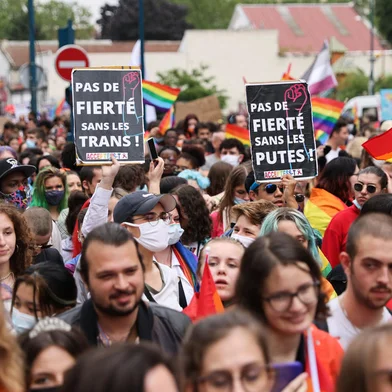 Participants hold signs reading "No pride without trans" as they take part at the annual Pride March parade in Paris on June 26, 2021. (Photo by THOMAS COEX / AFP)<!-- NICAID(14819818) -->