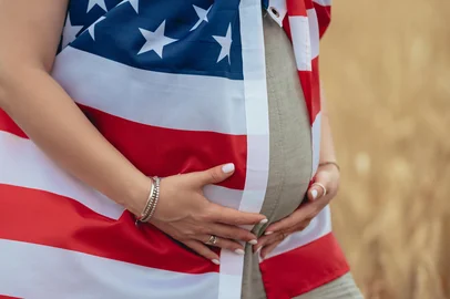 Pregnant Patriot Woman Belly with American National Flag In Wheat Field. USAAdobe StockPregnant Patriot Woman Belly with American National Flag In Wheat Field. Demography, population in USA. High quality photoFonte: 1017136140<!-- NICAID(16101563) -->