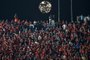 The waning gibbous moon rises behind a tree and spectators at Cairo International Stadium on June 4, 2023 during the first-leg final football match of the CAF Champions League, between Egypt's Al-Ahly and Morocco's Wydad AC. (Photo by Khaled DESOUKI / AFP)<!-- NICAID(15452194) -->