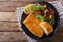 Fried Arctic char fish fillet in breadcrumbs and fresh vegetable salad close-up. horizontal top viewIndexador: FomaAFonte: 143123380<!-- NICAID(15664889) -->