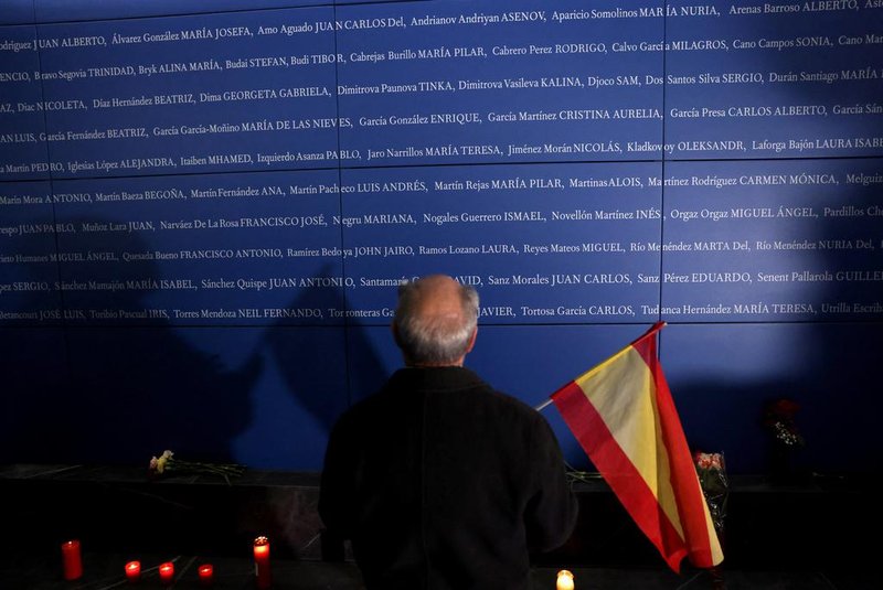 A man stands in front of a panel bearing names of the victims of the 11-M attacks, which killed 192 people on March 11, 2004, at a memorial space in Atocha station in Madrid on March 11, 2024. Spain marks the 20th anniversary of the attack that caused nearly 200 fatal victims, claimed by "al-Qaeda in Europe" as punishment for Spain's involvement in the war in Iraq. During the morning rush hour of March 11, 2004, ten bombs exploded nearly simultaneously on Madrids commuter trains, killing 192 people and injuring almost 2,000. The shockwave caused by the terrorist attacks - the deadliest ever committed on Spanish soil - weakened the PP which was criticised for insisting ETA was to blame despite mounting evidence to the contrary. (Photo by Thomas COEX / AFP)<!-- NICAID(15701751) -->