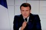 O presidente francês Emmanuel Macron é visto em uma tela de TV enquanto fala durante um discurso televisionado sobre as novas restrições Covid-19 do Palácio do Eliseu em Paris em 31 de março de 2021. (Foto de Ludovic MARIN / AFP)<!-- NICAID(14748015) -->