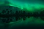Green aurora borealis lights reflected on the surface of a small lake in the woods in FinlandIndexador: Jani KatajistoFonte: 649924810<!-- NICAID(15715374) -->