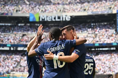 Paris Saint-Germain's Spanish midfielder #08 Fabian Ruiz (R) celebrates scoring his team's first goal with French forward #10 Ousmane Dembele during the FIFA Club World Cup 2025 semifinal football match between France's Paris Saint-Germain and Spain's Real Madrid at the MetLife stadium in East Rutherford, New Jersey on July 9, 2025. (Photo by ANGELA WEISS / AFP)<!-- NICAID(16077111) -->