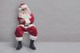 Bored Santa Claus sitting on a chair and waiting for a job interviewFonte: 537234602<!-- NICAID(15629824) -->
