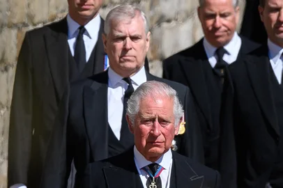 (FILES) Britain's Prince William, Duke of Cambridge, (back-L), Britain's Prince Andrew, Duke of York, (centre-L) and Britain's Prince Charles, Prince of Wales (front) follow the coffin during the ceremonial funeral procession of Britain's Prince Philip, Duke of Edinburgh to St George's Chapel in Windsor Castle in Windsor, west of London, on April 17, 2021. UK police said on February 19, 2026 officers were searching two addresses, one in eastern England and one west of London, following the arrest of ex-Prince Andrew on suspicion of misconduct in a public office with King Charles III saying in a statement "the law must take its course" (Photo by LEON NEAL / POOL / AFP)<!-- NICAID(16228241) -->