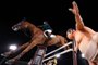 Brazil's Marlon Modolo Zanotelli riding Edgar M competes past a small sumo wrestler statue in the equestrian's jumping individual qualifying during the Tokyo 2020 Olympic Games at the Equestrian Park in Tokyo on August 3, 2021. (Photo by Behrouz MEHRI / AFP)<!-- NICAID(14855897) -->