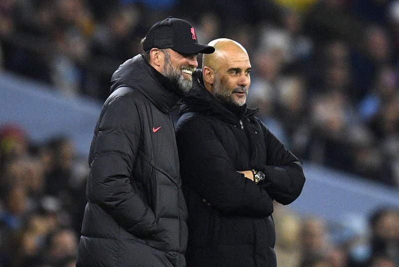 Liverpool's German manager Jurgen Klopp (L) and Manchester City's Spanish manager Pep Guardiola react during the English League Cup fourth round football match between Manchester City and Liverpool, at the Etihad stadium in Manchester on December 22, 2022. (Photo by Oli SCARFF / AFP) / RESTRICTED TO EDITORIAL USE. No use with unauthorized audio, video, data, fixture lists, club/league logos or 'live' services. Online in-match use limited to 120 images. An additional 40 images may be used in extra time. No video emulation. Social media in-match use limited to 120 images. An additional 40 images may be used in extra time. No use in betting publications, games or single club/league/player publications. / Editoria: SPOLocal: ManchesterIndexador: OLI SCARFFSecao: soccerFonte: AFPFotógrafo: STR<!-- NICAID(15703492) -->