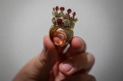(FILES) A gold, ruby, and diamond crown ring, designed and worn by the late US rapper Tupac Shakur during his last public appearance in 1996, is displayed during a press preview at Sotheby's in New York City on July 20, 2023. A gold, ruby and diamond crown ring worn by rap legend Tupac Shakur during his last public appearance sold for $1 million at auction in New York on July 25, 2023. The winning bid was well above Sotheby's pre-sale estimate of between $200,000 and $300,000 and becomes the most valuable hip-hop artifact ever sold, the auction house said. (Photo by Ed JONES / AFP)<!-- NICAID(15492285) -->