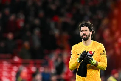 Liverpool's Brazilian goalkeeper #01 Alisson Becker reacts at the end of the last 16 second leg UEFA Champions League football match between Liverpool and Paris Saint-Germain (PSG) at Anfield in Liverpool, north west England on March 11, 2025. Paris Saint-Germain progressed to the quarter-finals of the Champions League after beating Liverpool 4-1 in a penalty shoot-out to win an epic last-16 tie between the clubs. (Photo by Oli SCARFF / AFP)<!-- NICAID(15993772) -->