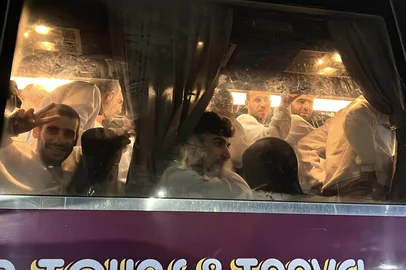 Palestinian prisoners, released by Israel, gesture as they arrive on a bus at the European Hospital in Khan Yunis in the southern Gaza Strip early on February 27, 2025. Hamas handed over the coffins of four hostages early on February 27, Israeli authorities confirmed, followed soon after by the return of hundreds of freed Palestinian prisoners to the West Bank and Gaza. In the West Bank and Gaza, AFP journalists saw hundreds of Palestinian prisoners freed by Israel arrive on buses accompanied by Red Cross vehicles. More than 600 were due to be released in the latest exchange, while Al Jazeera reported nearly 100 would be deported to Egypt. (Photo by AFP)<!-- NICAID(15984870) -->
