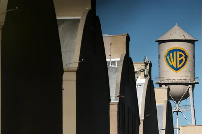 The WB water tower is seen at Warner Bros. Studios, Burbank in Burbank, California on December 5, 2025. Streaming giant Netflix said December 5, 2025 it will buy film and television studio Warner Bros. Discovery for nearly $83 billion, the entertainment industry's biggest consolidation deal this decade. The acquisition gives Netflix access to a vast film catalog as well as the prestigious streaming service HBO Max. (Photo by Patrick T. Fallon / AFP)<!-- NICAID(16181358) -->