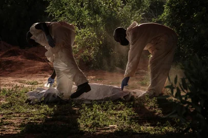 (FILES) Digged holes are seen after exhuming bodies at the mass-grave site in Shakahola, outside the coastal town of Malindi, on April 25, 2023. The death toll in an investigation linked to a Kenyan cult that practised starvation to "meet Jesus Christ" has exceeded 400 after 12 new bodies were found on July 17, 2023, a senior official said. (Photo by Yasuyoshi Chiba / AFP)<!-- NICAID(15485802) -->