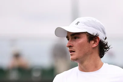 Brazil's Joao Fonseca reacts as he plays against US player Jenson Brooksby during their men's singles second round tennis match on the third day of the 2025 Wimbledon Championships at The All England Lawn Tennis and Croquet Club in Wimbledon, southwest London, on July 2, 2025. (Photo by HENRY NICHOLLS / AFP) / RESTRICTED TO EDITORIAL USE<!-- NICAID(16072465) -->
