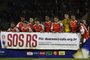 Internacional players pose for a picture with a banner asking for donations for the victims of the devastating floods that affected Rio Grande do Sul state in Brazil, before the Copa Sudamericana group stage second leg football match between Brazil's Internacional and Argentina's Belgrano at Arena Barueri stadium in Sao Paulo on May 28, 2024. (Photo by Miguel Schincariol / AFP)Editoria: SPOLocal: Sao PauloIndexador: MIGUEL SCHINCARIOLSecao: soccerFonte: AFPFotógrafo: STR<!-- NICAID(15775879) -->