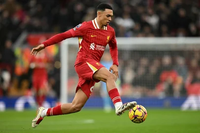 (FILES) Liverpool's English defender #66 Trent Alexander-Arnold controls the ball during the English Premier League football match between Liverpool and Fulham at Anfield in Liverpool, north west England on December 14, 2024. Trent Alexander-Arnold announced on May 5, 2025 he will leave boyhood club Liverpool when his contract expires at the end of the season, saying it was the "hardest decision" of his life. The England defender, who helped Liverpool win the Premier League this season, has been heavily linked with a free transfer to Real Madrid. (Photo by Oli SCARFF / AFP) / RESTRICTED TO EDITORIAL USE. No use with unauthorized audio, video, data, fixture lists, club/league logos or 'live' services. Online in-match use limited to 120 images. An additional 40 images may be used in extra time. No video emulation. Social media in-match use limited to 120 images. An additional 40 images may be used in extra time. No use in betting publications, games or single club/league/player publications. / <!-- NICAID(16029896) -->