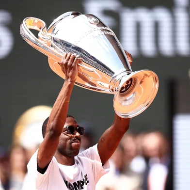 Paris Saint-Germain's French forward Ousmane Dembele brings the UEFA Champions League's trophy on Court Philippe-Chatrier as part of the French Open tennis tournament on day 9 at the Roland-Garros Complex in Paris on June 2, 2025. Paris Saint-Germain won the Champions League for the first time in their history,  outclassing Inter Milan on May 31, 2025, in the most one-sided final ever in an astonishing 5-0 victory. (Photo by Alain JOCARD / AFP)<!-- NICAID(16050862) -->