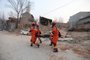 Rescue workers carry a victim after an earthquake in Dahejia, Jishishan County, in northwest Chinas Gansu province on December 19, 2023. At least 111 people were killed when an earthquake collapsed buildings in northwest China, state media reported on December 19, as rescue workers raced to start digging through rubble. (Photo by AFP) / China OUT<!-- NICAID(15629695) -->