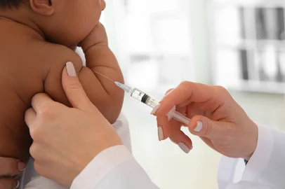 Pediatrician giving little baby an injection in clinic<!-- NICAID(15616950) -->