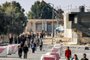 Palestinian workers, who were stranded in Israel since the October 7 attacks, walk near the Rafah border crossing with Egypt as they make their way to cross back into the Gaza Strip at the Kerem Shalom commercial border crossing with Israel in the south of the Palestinian enclave on November 3, 2023. (Photo by SAID KHATIB / AFP)<!-- NICAID(15587300) -->