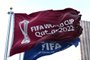 Doha, Qatar, January 2022: Flags with FIFA and Qatar 2022 World Cup logo waving in the wind. The event is scheduled in Qatar from 21 November to 18 December 2022Fonte: 484210091<!-- NICAID(15253832) -->
