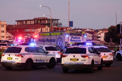 Police vehicles are seen on a road after a shooting incident at Bondi Beach in Sydney on December 14, 2025. Australian police said two people were in custody following reports of multiple gunshots on December 14 at Sydney's famed Bondi Beach, urging the public to take shelter. (Photo by DAVID GRAY / AFP)<!-- NICAID(16186378) -->