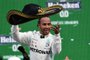 Mercedes' British driver Lewis Hamilton celebrates at the podium after winning the F1 Mexico Grand Prix, at the Hermanos Rodriguez racetrack in Mexico City on October 27, 2019. (Photo by PEDRO PARDO / AFP)<!-- NICAID(14305639) -->