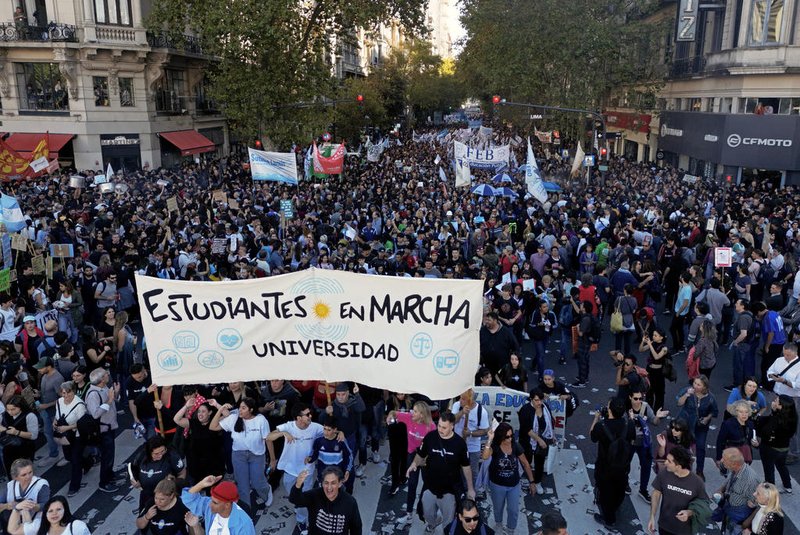 Demonstrators march in protest of the budget adjustment to public universities in Buenos Aires on April 23, 2024. Tens of thousands of Argentine university students took to the streets Tuesday to protest cuts to higher public education, research and science under budget-slashing new President Javier Milei. (Photo by Luis ROBAYO / AFP)<!-- NICAID(15747546) -->