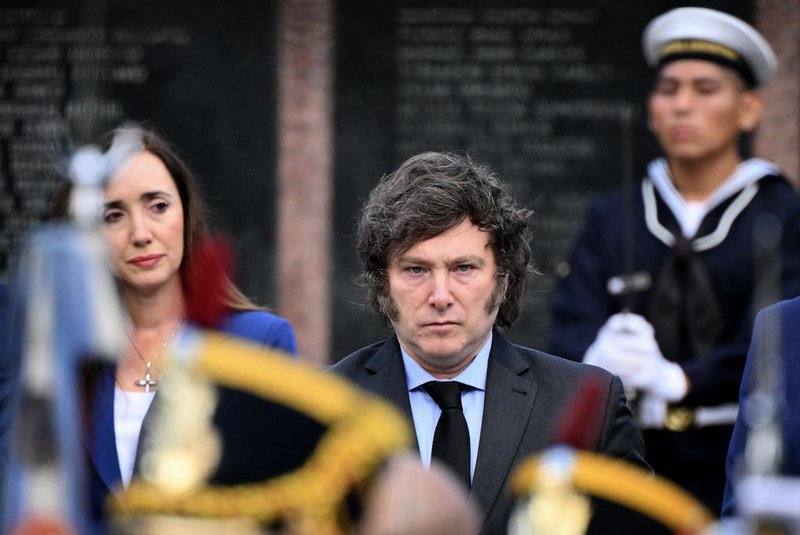 Argentina's President Javier Milei (C) and his vice president Victoria Villaruel (L) take part in a ceremony to commemorate the 42nd anniversary of the war between Argentina and the United Kingdom over the Malvinas/Falkland islands, at the Cenotaph to the Fallen of the Malvinas War in Buenos Aires, on April 2, 2024. (Photo by Luis ROBAYO / AFP)<!-- NICAID(15723301) -->