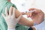 Close up of a Doctor making a vaccination in the shoulder of patient, Flu Vaccination Injection on Arm, coronavirus, covid-19 vaccine disease preparing for human clinical trials vaccination shot.<!-- NICAID(15616952) -->