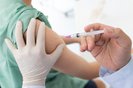 Close up of a Doctor making a vaccination in the shoulder of patient, Flu Vaccination Injection on Arm, coronavirus, covid-19 vaccine disease preparing for human clinical trials vaccination shot.<!-- NICAID(15616952) -->