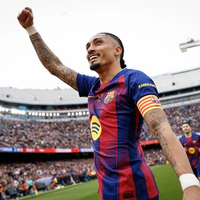 Barcelona's Brazilian forward #11 Raphinha celebrates scoring his team's second goal from the penalty spot during the Spanish League football match between FC Barcelona and Sevilla FC at the Camp Nou Stadium in Barcelona, on March 15, 2026. (Photo by Lluis GENE / AFP)<!-- NICAID(16245466) -->