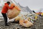 This picture taken on July 16, 2023, shows a man collecting litter from K2 at Basecamp, worlds second tallest mountain in the Karakoram range of GilgitBaltistan, Pakistan. Gazing up from K2 Basecamp, Sajid Ali Sadpara sees Earth's second highest mountain, his father's final resting place, and a blight of litter on the furthest reaches of the natural world. Over a week some 200 kilograms (400 pounds) of litter is hacked from the pinnacle's frozen grip by his five-strong team and ferried precariously back down, a rare act of charity in one of Earth's most unforgiving environments. (Photo by Joe STENSON / AFP)Editoria: ENVLocal: GilgitIndexador: JOE STENSONSecao: mountainsFonte: AFPFotógrafo: STF<!-- NICAID(15506569) -->