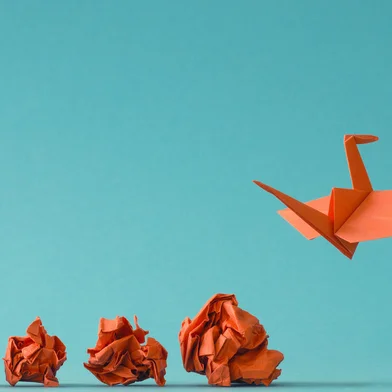 New ideas or transformation concept with crumpled paper balls and a crane, teamwork, creativity, business concept<!-- NICAID(15810057) -->
