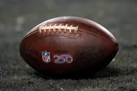 CHICAGO, ILLINOIS - JANUARY 10: A detailed view of an NFL football between the Chicago Bears and the Green Bay Packers with an America 250 decal in the NFC Wild Card Playoff game at Soldier Field on January 10, 2026 in Chicago, Illinois.   Patrick McDermott/Getty Images/AFP (Photo by Patrick McDermott / GETTY IMAGES NORTH AMERICA / Getty Images via AFP)<!-- NICAID(16205478) -->