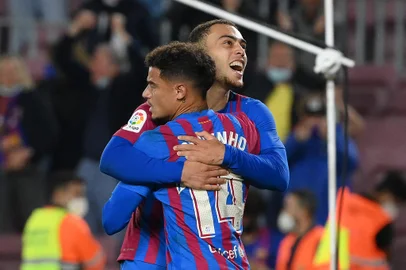 Barcelona's Brazilian midfielder Philippe Coutinho (Front) celebrates with Barcelona's US defender Sergino Dest after scoring his team's third goal during the Spanish league football match between FC Barcelona and Valencia CF at the Camp Nou stadium in Barcelona on October 17, 2021. (Photo by LLUIS GENE / AFP)<!-- NICAID(14917798) -->