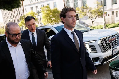 Meta CEO and Chairman Mark Zuckerberg (R) arrives at Los Angeles Superior Court ahead of the social media trial tasked to determine whether social media giants deliberately designed their platforms to be addictive to children, in Los Angeles, on February 18, 2026. Zuckerberg is scheduled to testify Wednesday. (Photo by Patrick T. Fallon / AFP)<!-- NICAID(16227753) -->