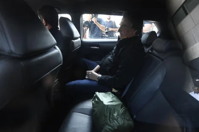 Former Brazilian President Jair Bolsonaro sits in a car as he leaves the Santos Dumont Airport in Rio de Janeiro, Brazil, on June 29, 2023. Judges will continue  delivering verdicts Thursday on charges that far-right ex-president Jair Bolsonaro broke the law with his unproven allegations against Brazil's election system, which could see him banned from holding office for eight years. (Photo by MAURO PIMENTEL / AFP)<!-- NICAID(15470267) -->