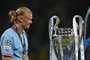 Manchester City's Norwegian striker #9 Erling Haaland walks past the European Cup trophy as they celebrate winning the UEFA Champions League final football match between Inter Milan and Manchester City at the Ataturk Olympic Stadium in Istanbul, on June 10, 2023. Manchester City won the match 1-0. (Photo by Paul ELLIS / AFP)Editoria: SPOLocal: IstanbulIndexador: PAUL ELLISSecao: soccerFonte: AFPFotógrafo: STF<!-- NICAID(15453027) -->
