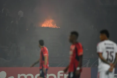Medellin fans set fire in the stands during the Copa Libertadores group stage football match between Colombia's Independiente Medellin and Brazil's Flamengo at the Atanasio Girardot stadium in Medellin, Antioquia department, Colombia on May 7, 2026. (Photo by Jaime SALDARRIAGA / AFP)<!-- NICAID(16281075) -->