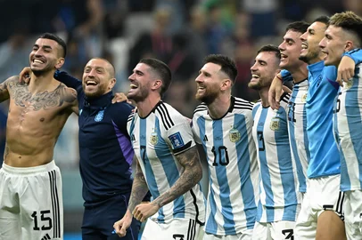 Argentina's forward #15 Angel Correa, Argentina's midfielder #17 Alejandro Gomez, Argentina's midfielder #07 Rodrigo De Paul, Argentina's forward #10 Lionel Messi, Argentina's defender #03 Nicolas Tagliafico, Argentina's forward #21 Paulo Dybala, Argentina's midfielder #05 Leandro Paredes and Argentina's defender #25 Lisandro Martinez celebrate with supporters after defeating Croatia 3-0 in the Qatar 2022 World Cup football semi-final match between Argentina and Croatia at Lusail Stadium in Lusail, north of Doha on December 13, 2022. (Photo by JUAN MABROMATA / AFP)<!-- NICAID(15294549) -->