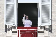 Pope Leo XIV waves to faithful during the Angelus prayer from the window of the Apostolic Palace overlooking St. Peter's Square, in the Vatican, on October 11, 2026. Pope Leo XIV on October 11, 2026 announced he would be operated "in the coming days" for a lump on his lung, saying it had been located "at a very early stage". "During recent medical checks, a nodule on my lung was found. It has been detected at a very early stage and is very localised," the 71-year-old said in a weekly address in St Peter's Square. (Photo by Filippo MONTEFORTE / AFP)<!-- NICAID(16384993) -->