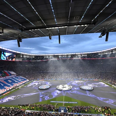 Fans follow the ceremony prior to the UEFA Champions League final football match between Paris Saint-Germain (PSG) and Inter Milan in Munich, southern Germany on May 31, 2025. (Photo by Kirill KUDRYAVTSEV / AFP)<!-- NICAID(16050618) -->